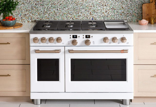 A modern white kitchen stove with multiple burners and ovens.