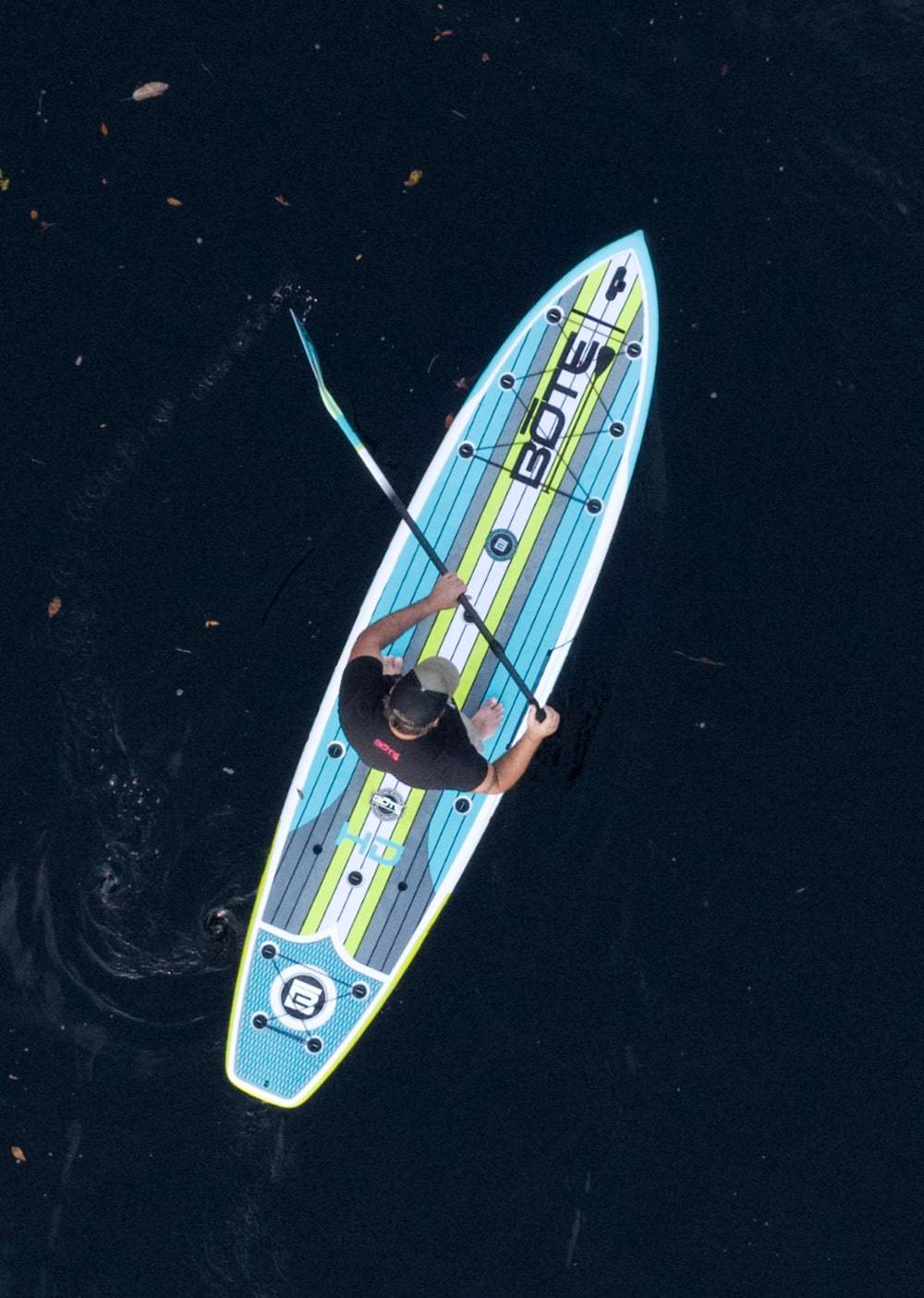 Overhead view of a man paddling his HD Full Trax Citron Paddle Board
