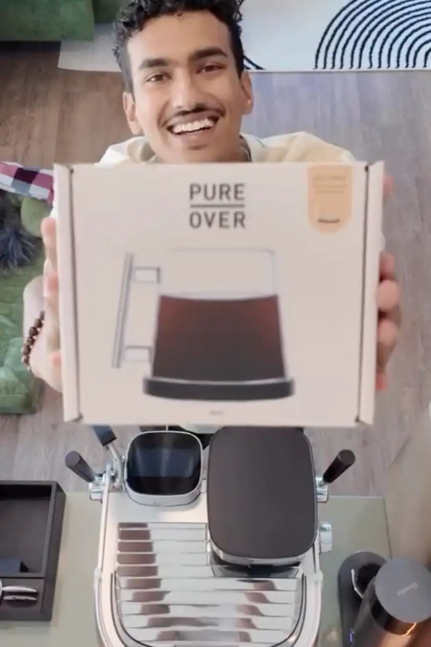 Person holding a box labeled 