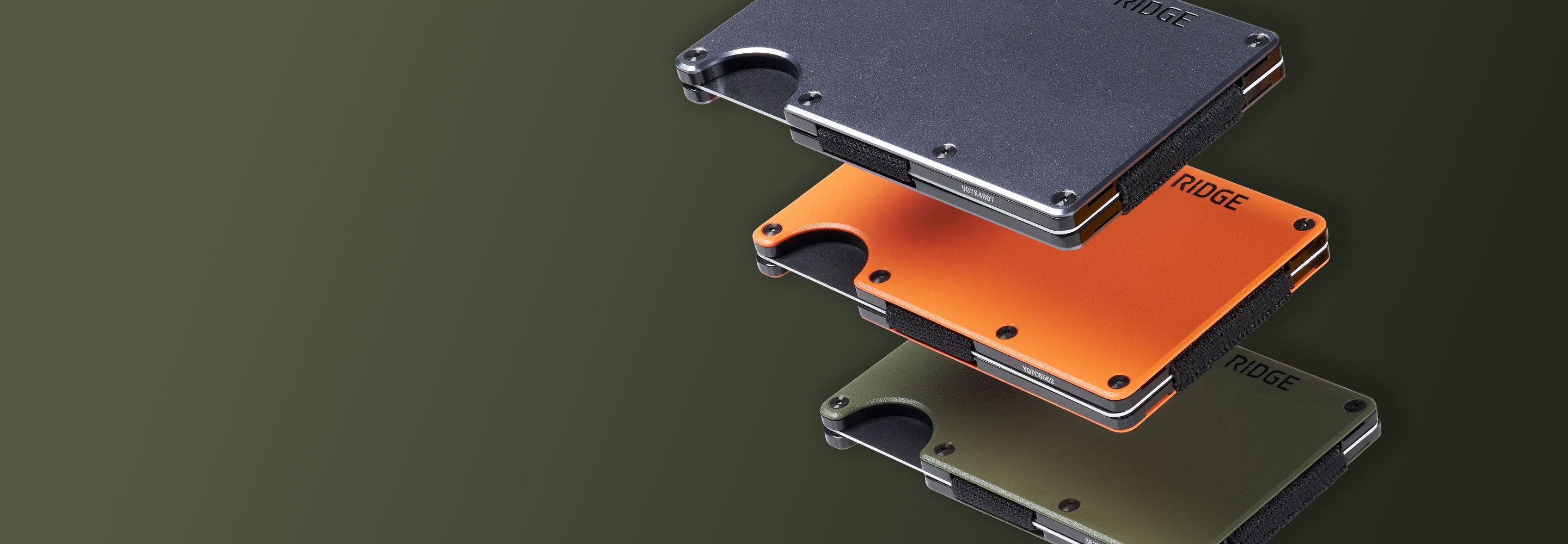 Three stacked wallets in black, orange, and green on a dark background.