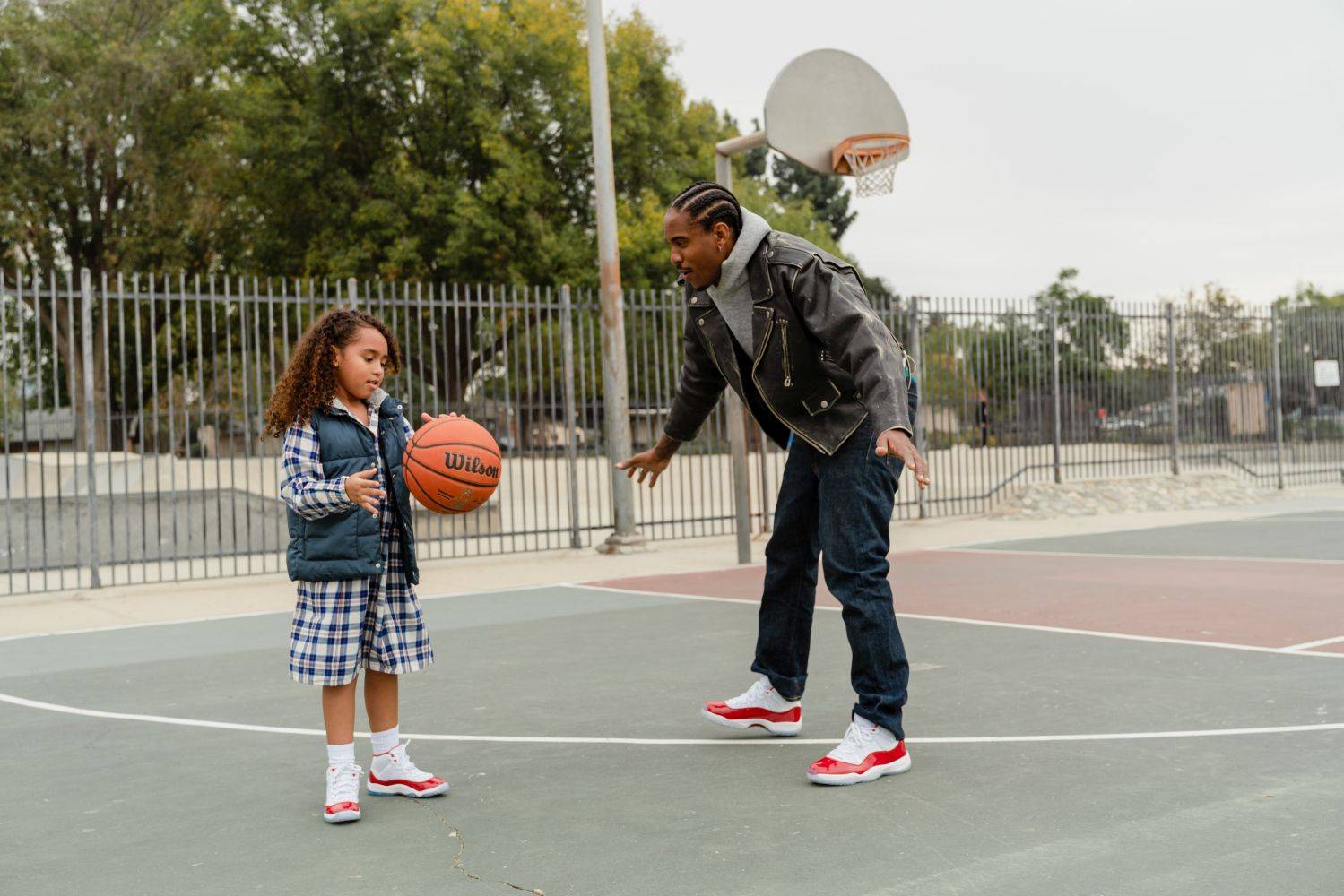 father and daughter playing basketball in aj11 retro cherry