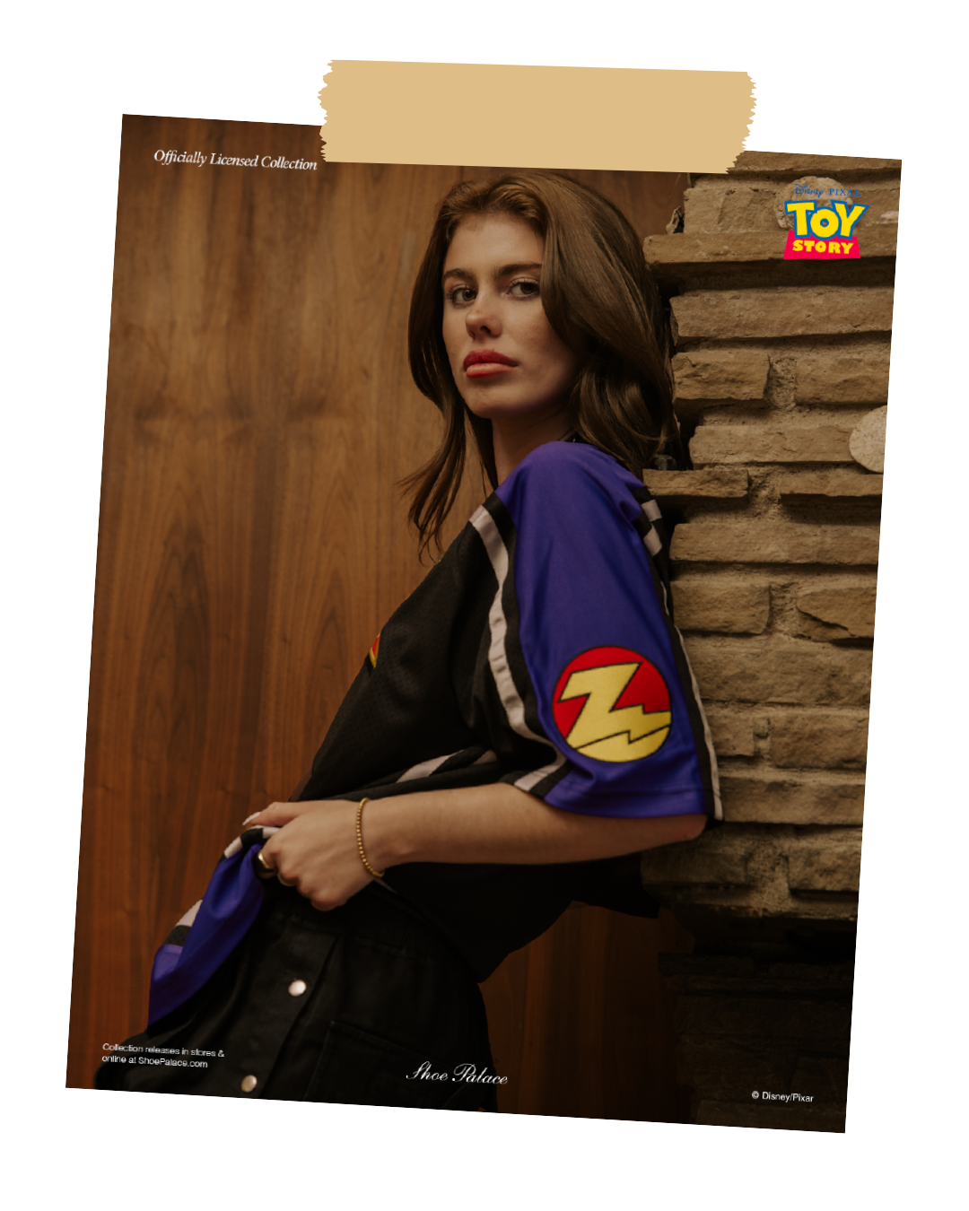 A woman in a stylish outfit poses against a wooden wall.