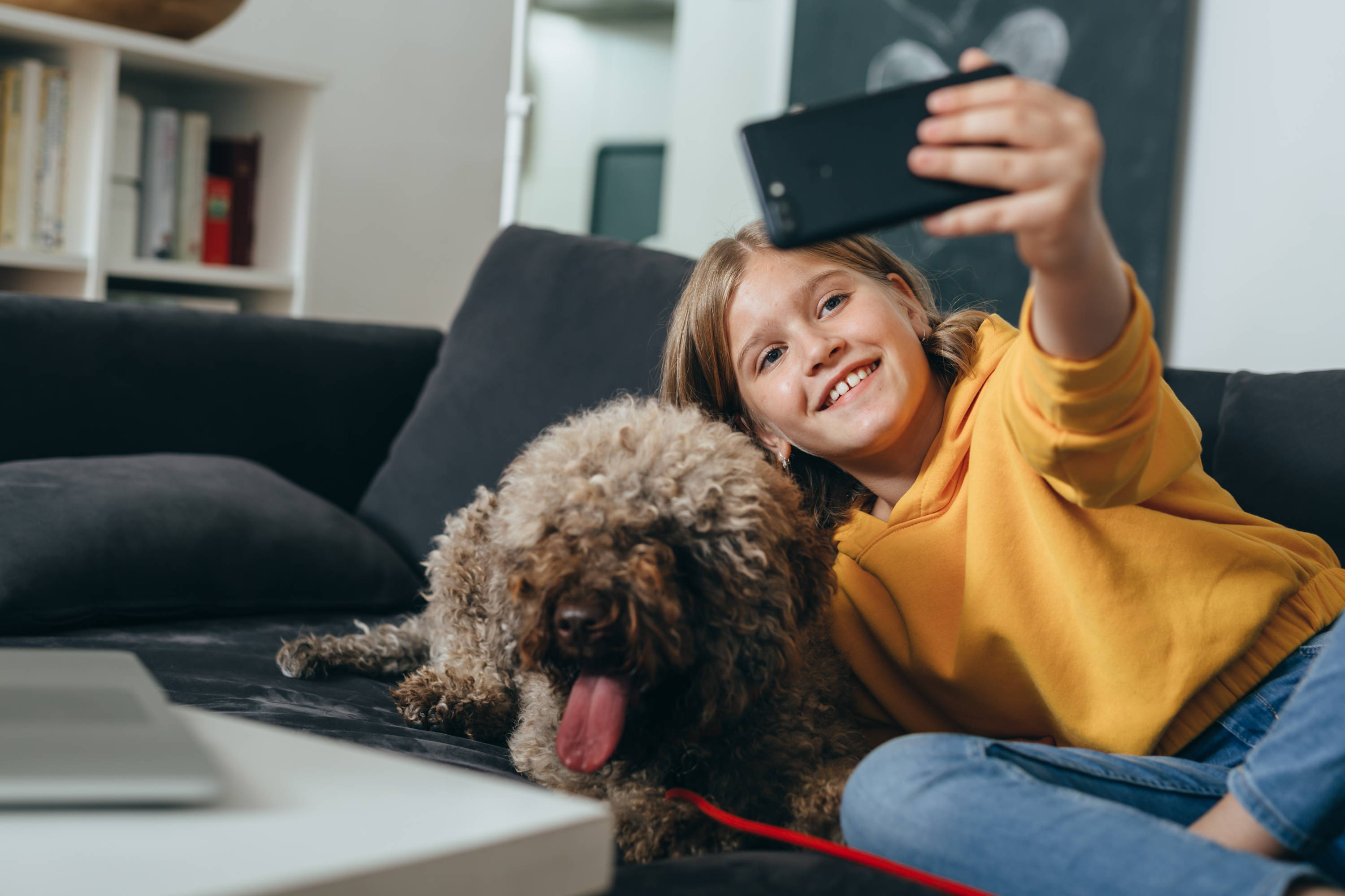 Kid with a dog on camera Phone and Gen Mobile phone plan.