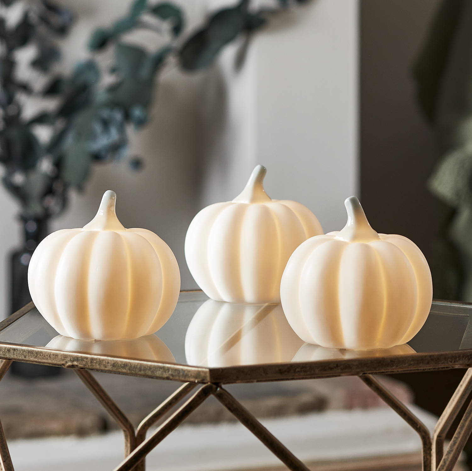 Trio of LED pumpkins in a living room setting