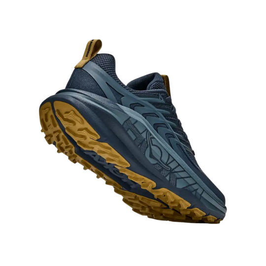 Close-up of a blue athletic shoe with a rugged sole.