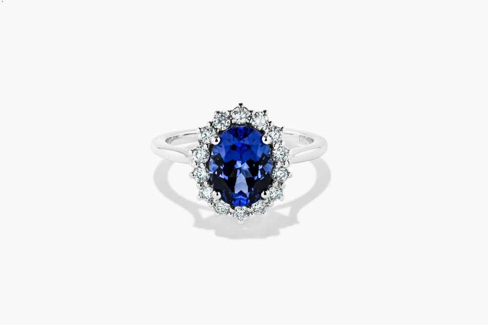 vintage diamond halo antique engagement ring shown with a blue sapphire lab grown gemstone by MiaDonna