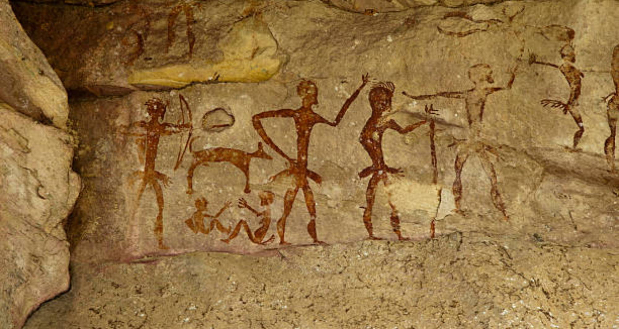 a cave drawing a five adults, a dog, and two children