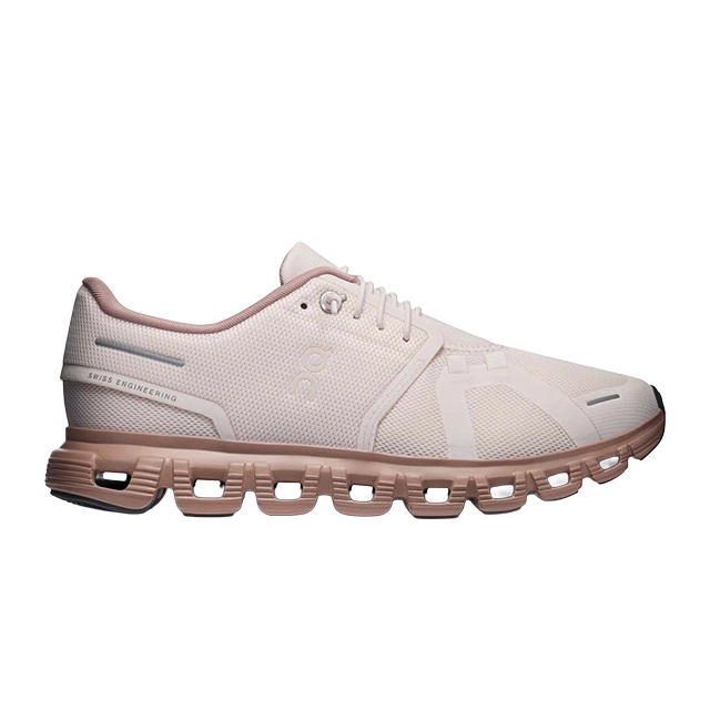 Light pink athletic shoe with a unique sole design.