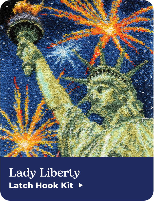 Latch hook kit featuring the Statue of Liberty with fireworks background.