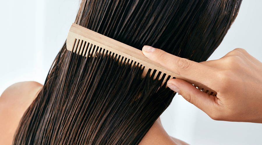 woman brushing wet hair