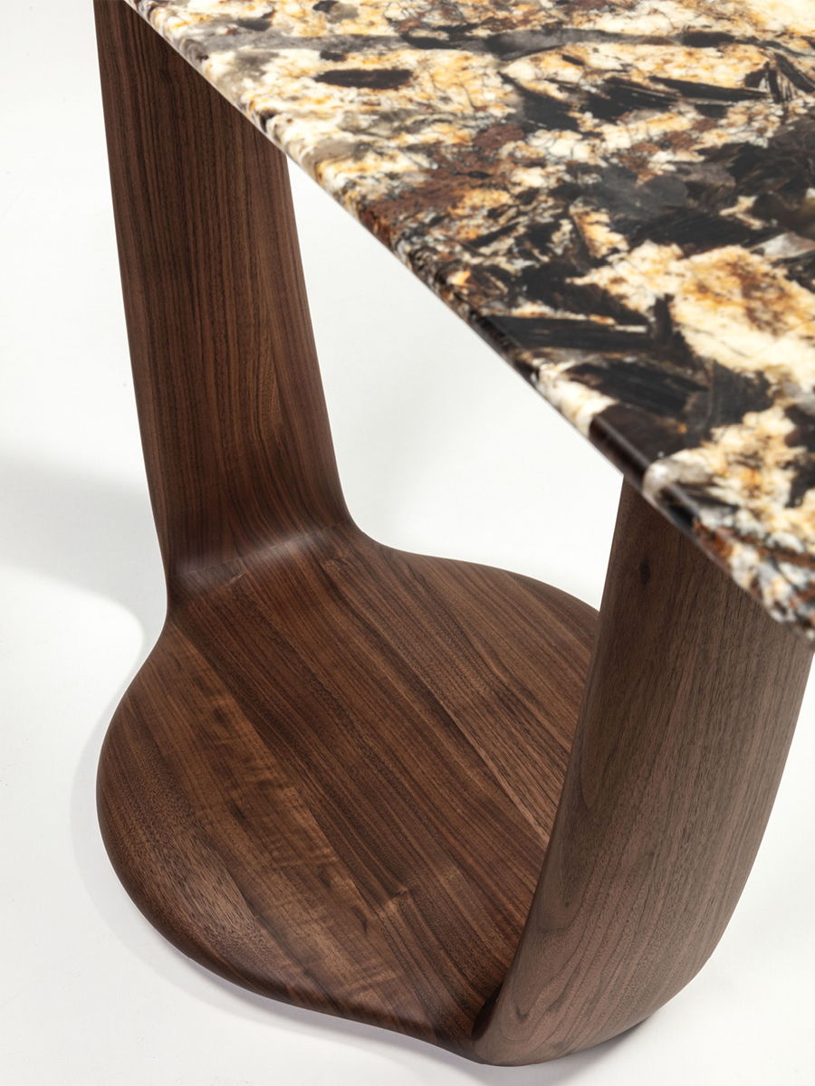 A modern Saddle console table with a marble top and wooden base.