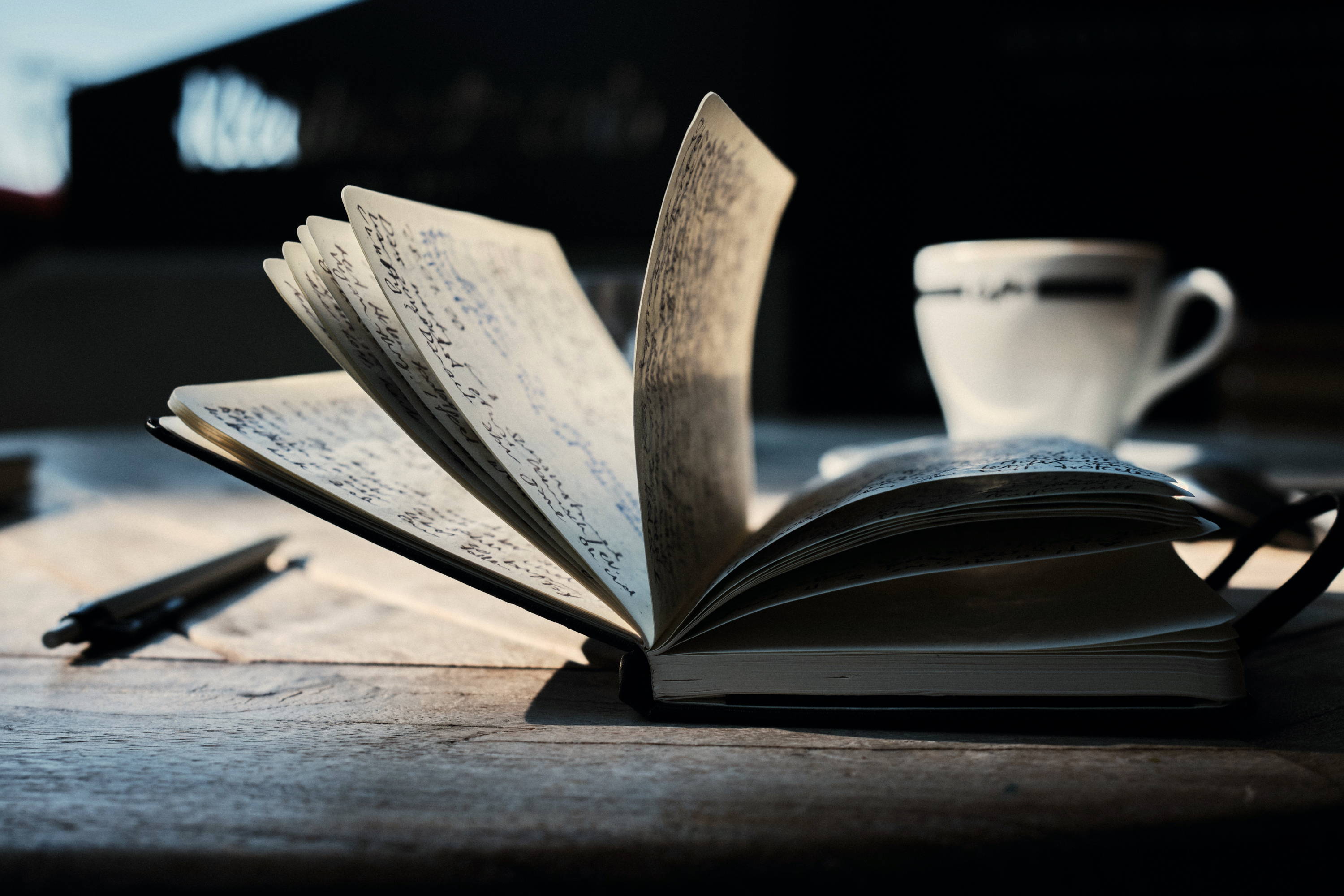 Open book on a brown wooden table