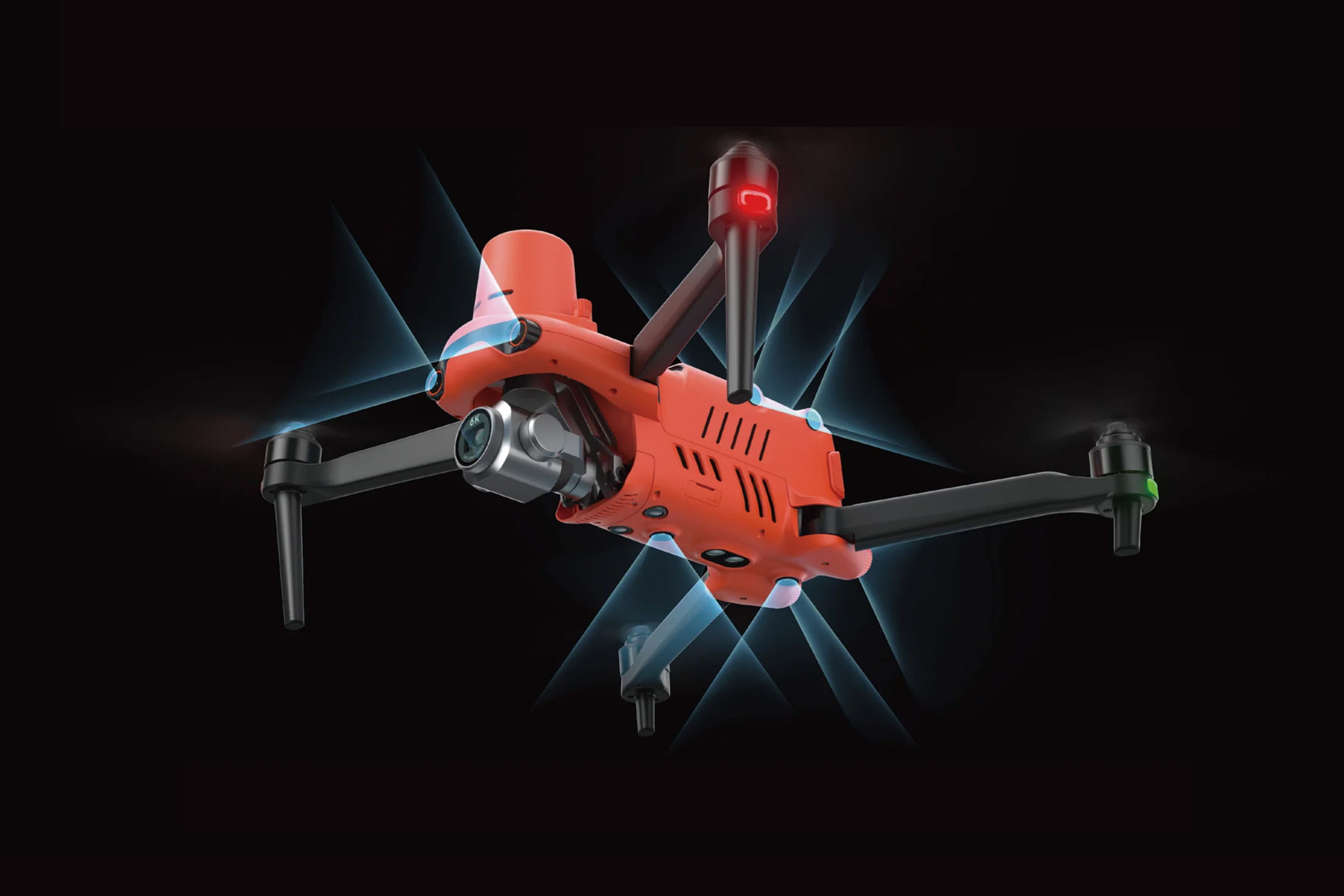 Orange drone flying against a dark background with glowing effects.
