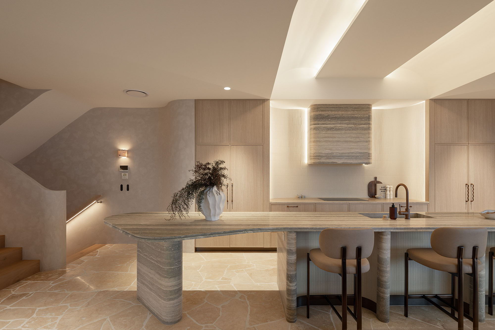 Modern kitchen with sleek design, island counter, and neutral color palette.