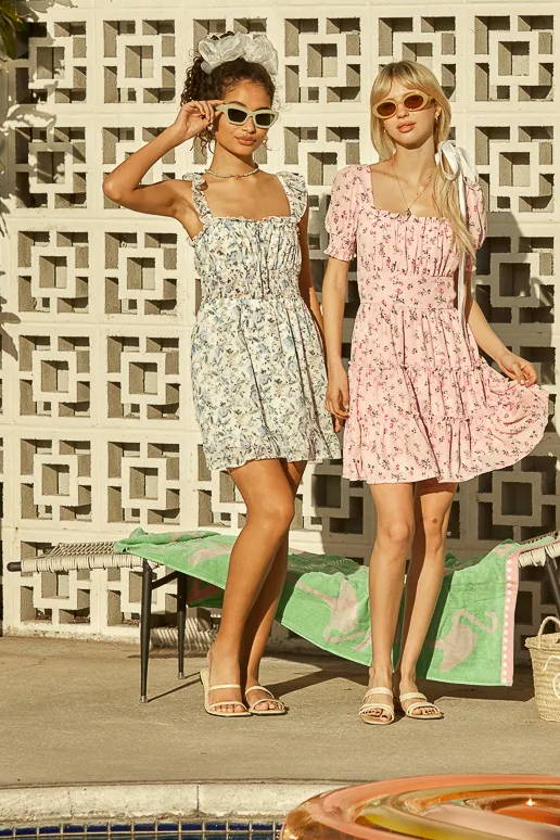 Trixxi Spring summer dress up getting ready to go to the pool in pink floral mini dress and blue ruffle mini dress.