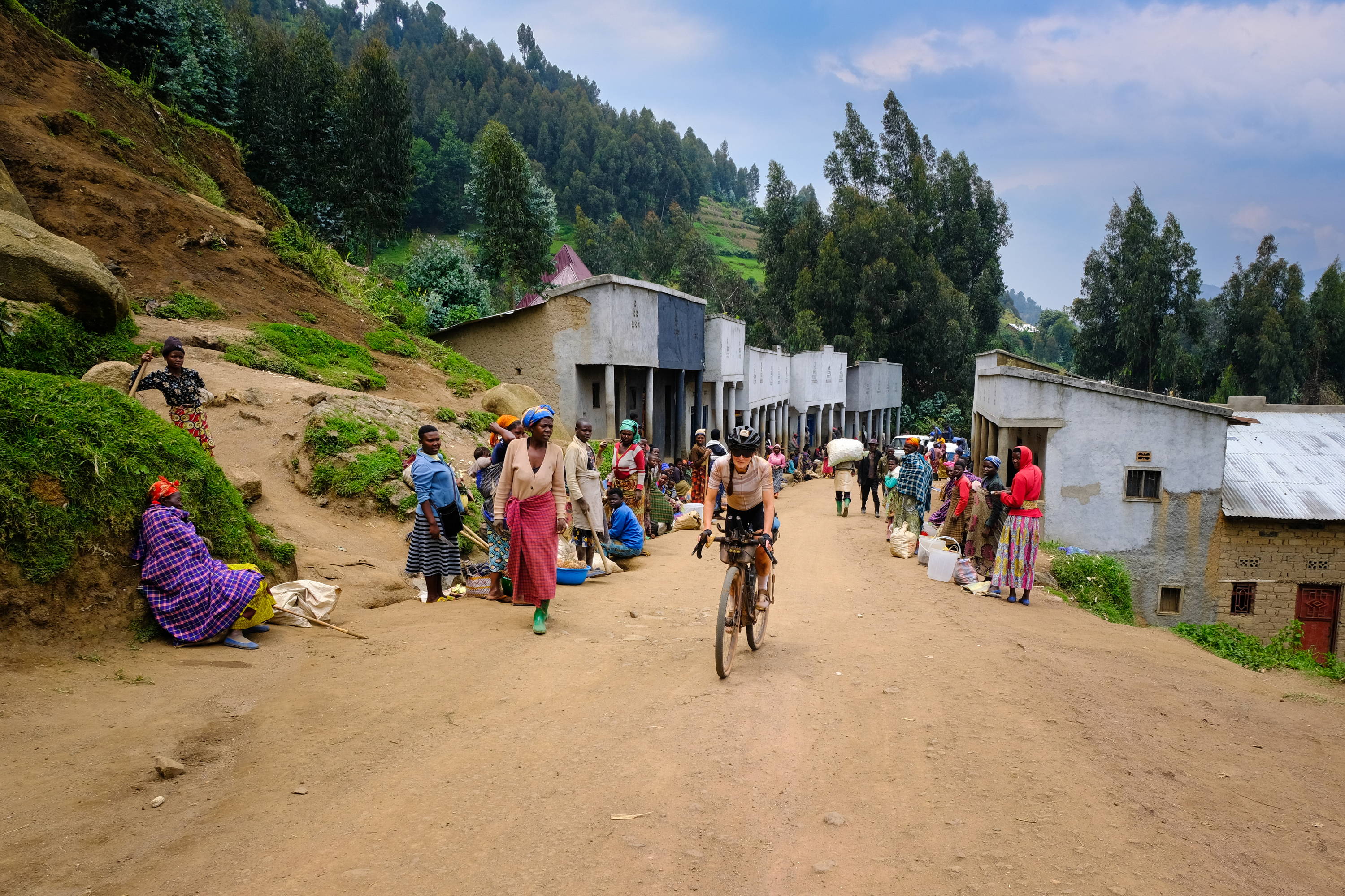 Katrien riding through a village in Rwanda