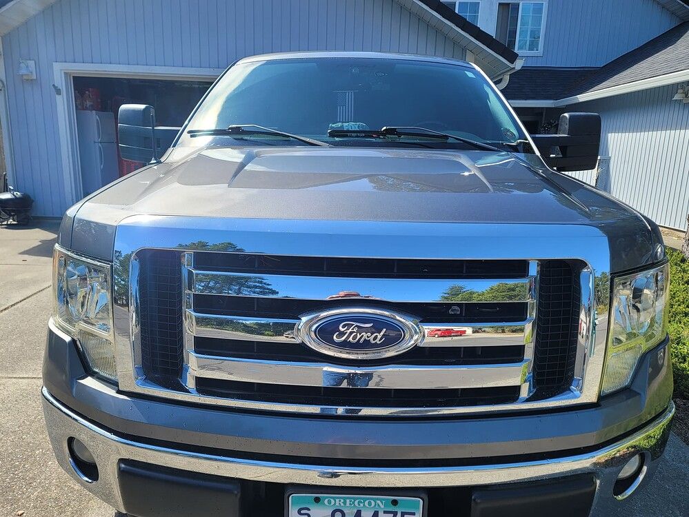  2011 Ford F-150 with HornBlasters Flatlaw Train Horn Kit mounted behind the front grille
