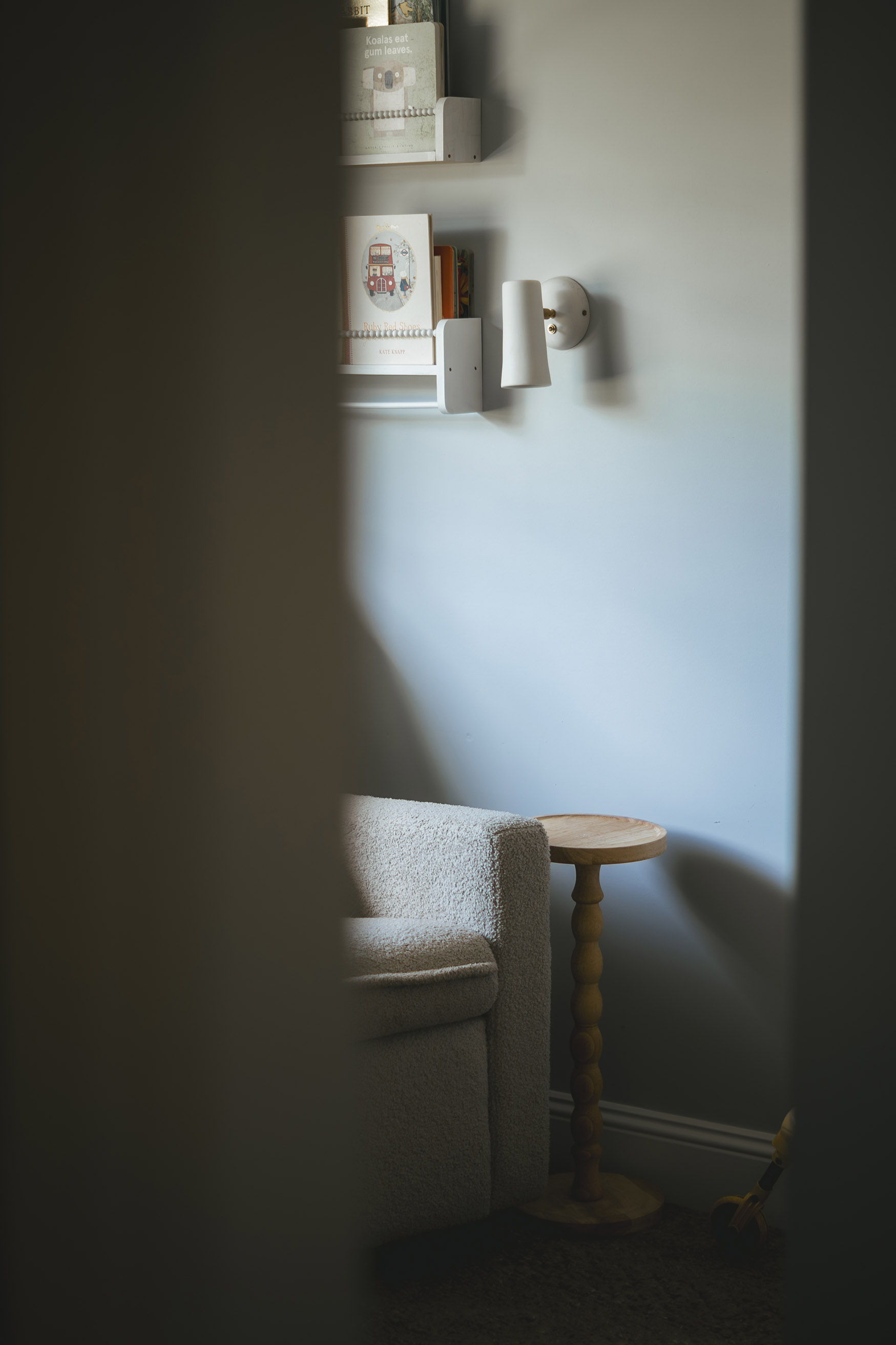 A cozy corner with a chair and a small table.