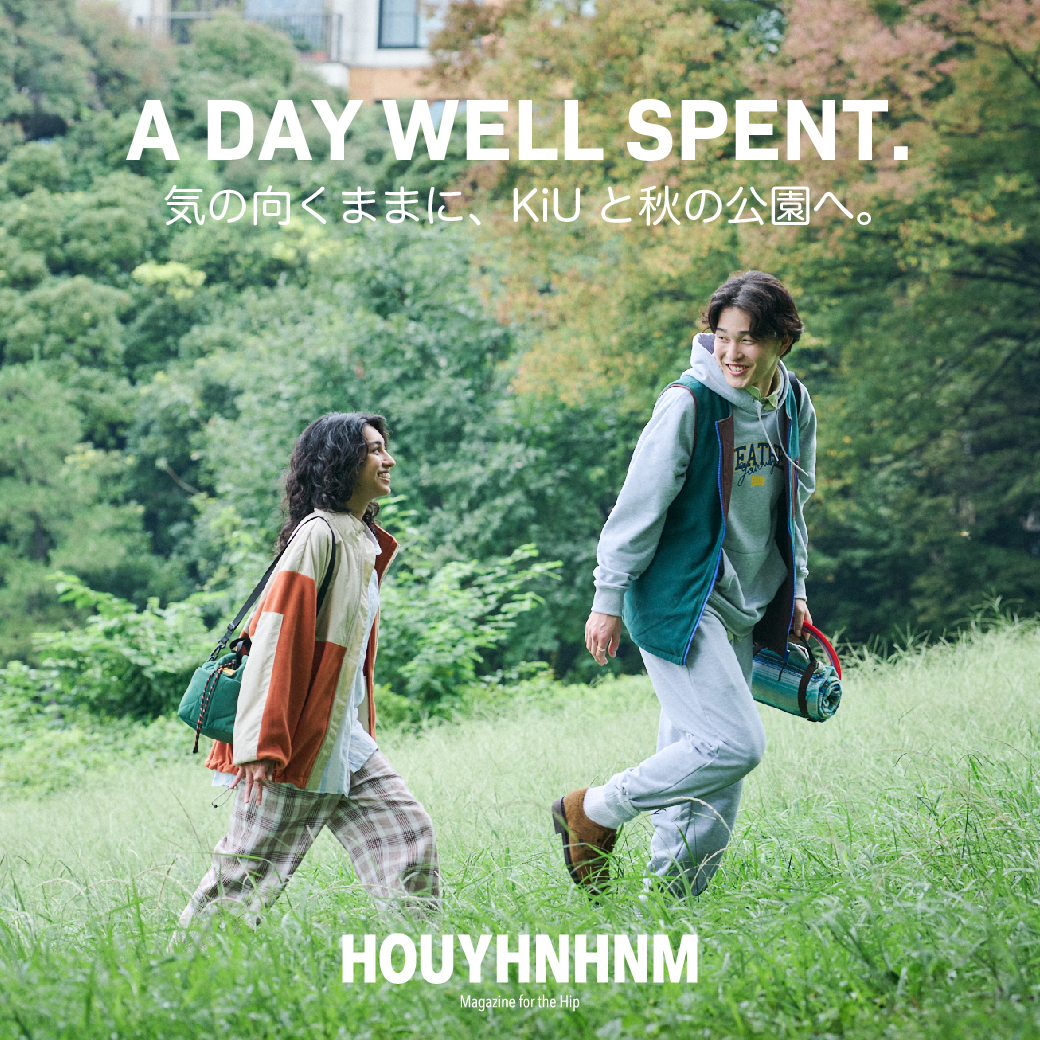 Two people walking in a lush green park, enjoying a sunny day.