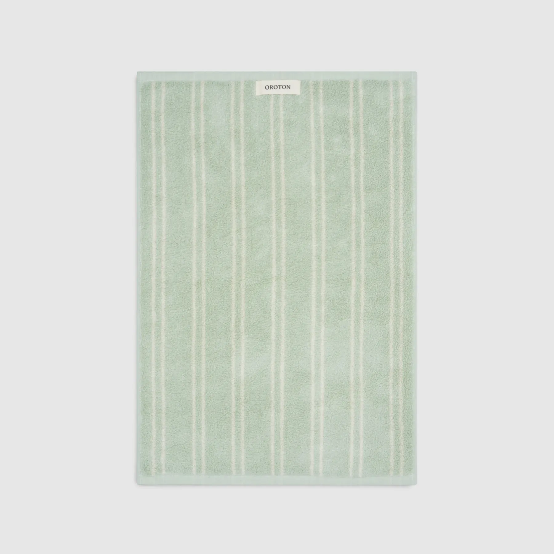 Green striped towel on a light background.