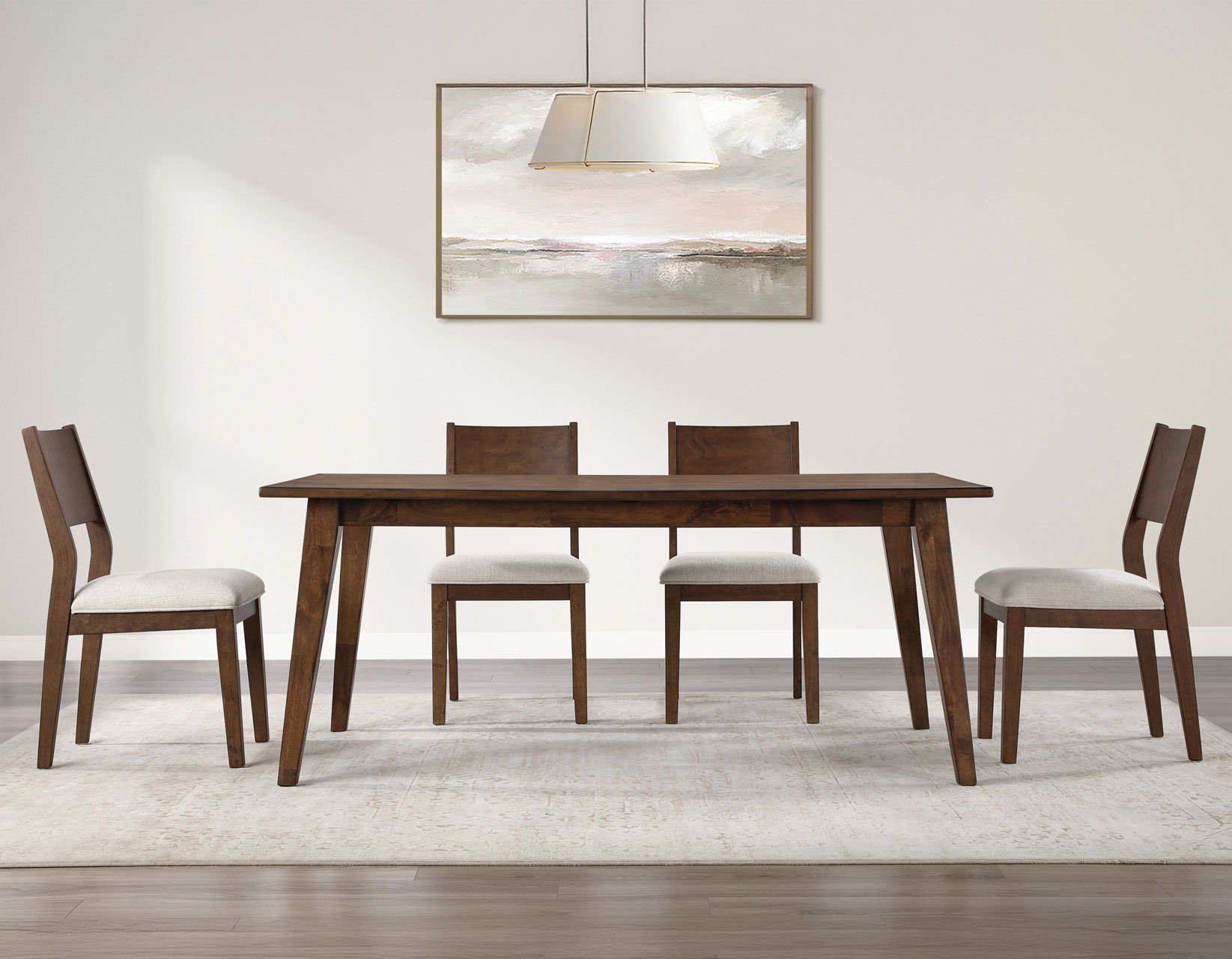 A modern dining table with four chairs and a wall art piece.