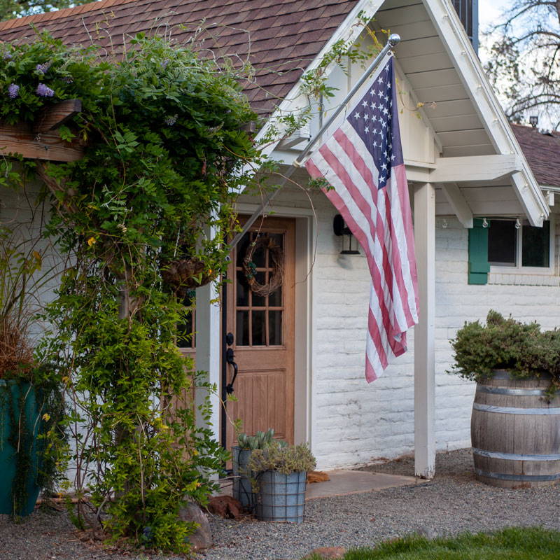 Front entrance to the AirBnB house with American flag outside.