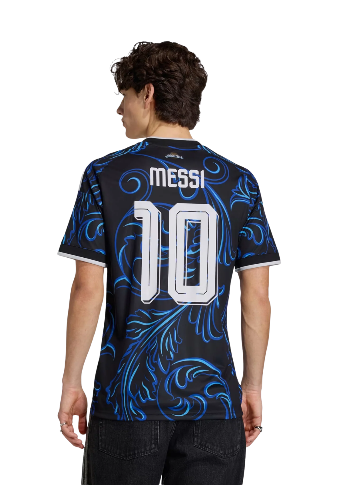 Young man wearing a black jersey with blue floral designs, posing confidently.