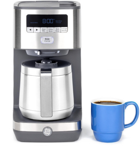 Coffee maker with a stainless steel carafe and a blue mug of coffee.