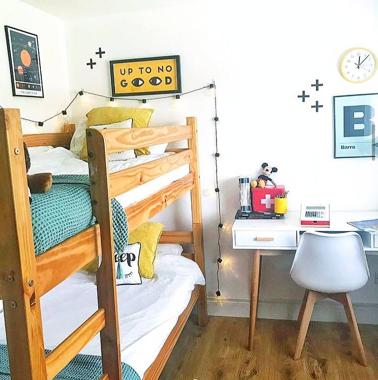 Festoon lights illuminated and displayed along wall next to bunk bed in children's bedroom 