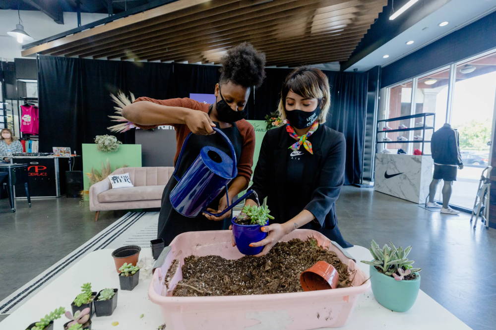 andi xoch helping girl with plants at for her event