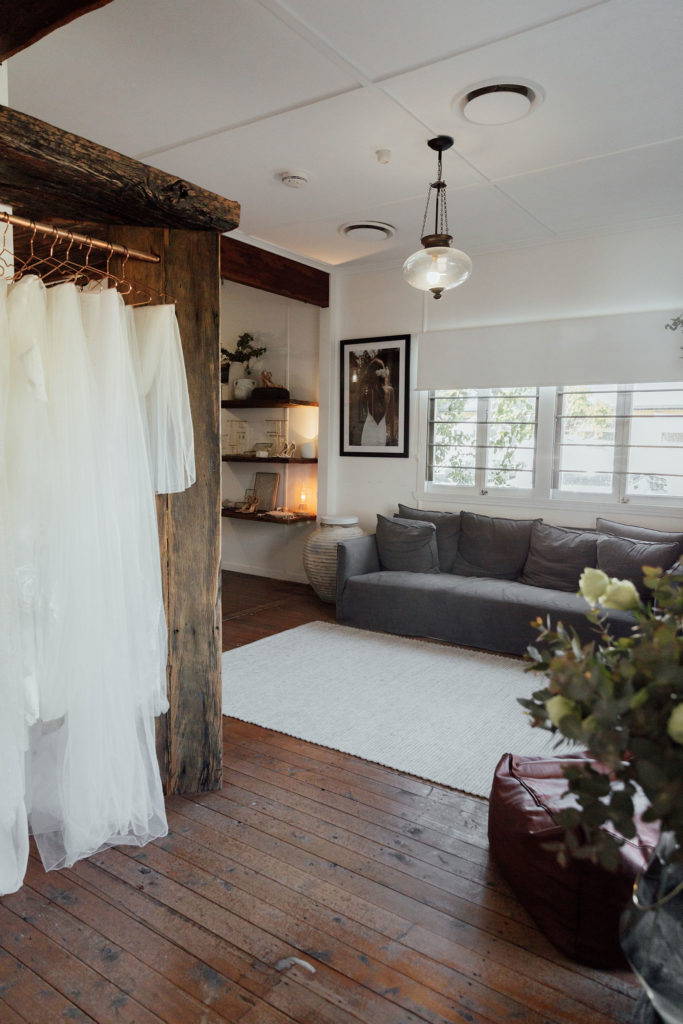 Cozy couch and thick heritage floorboards inside the Grace Loves Lace Gold Coast bridal showroom