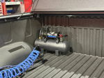 Truck bed corner HornBlasters compressor air tank blue coiled hose spray-in liner tonneau cover Jay's 2024 Tundra 228H gallery photo 8