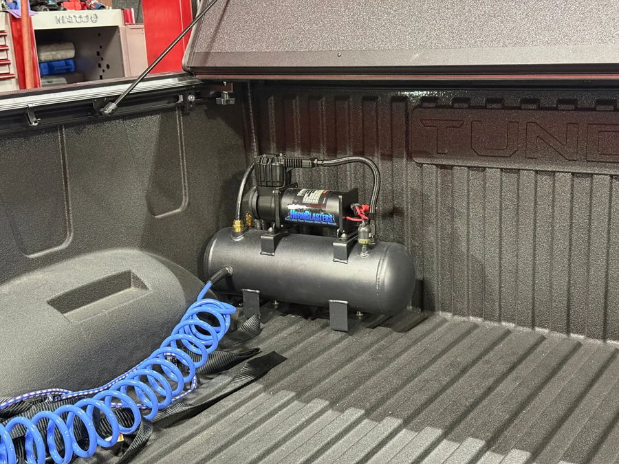 Truck bed corner HornBlasters compressor air tank blue coiled hose spray-in liner tonneau cover Jay's 2024 Tundra 228H gallery photo 8