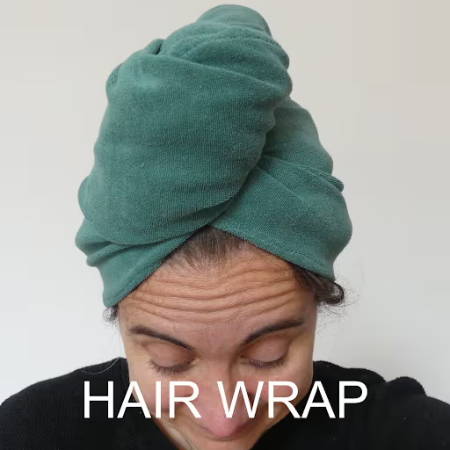 Green hand-made hair wrap on a women’s head made out of towel fabric