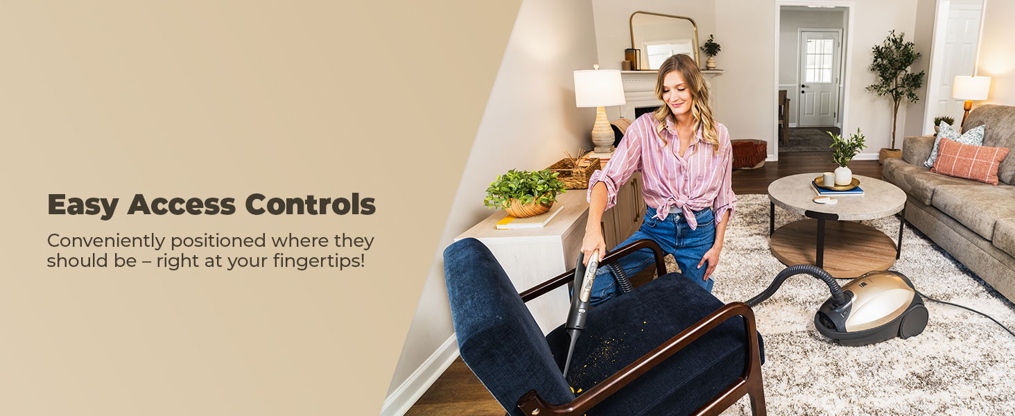 Woman using a vacuum in a stylish living room with easy access controls.