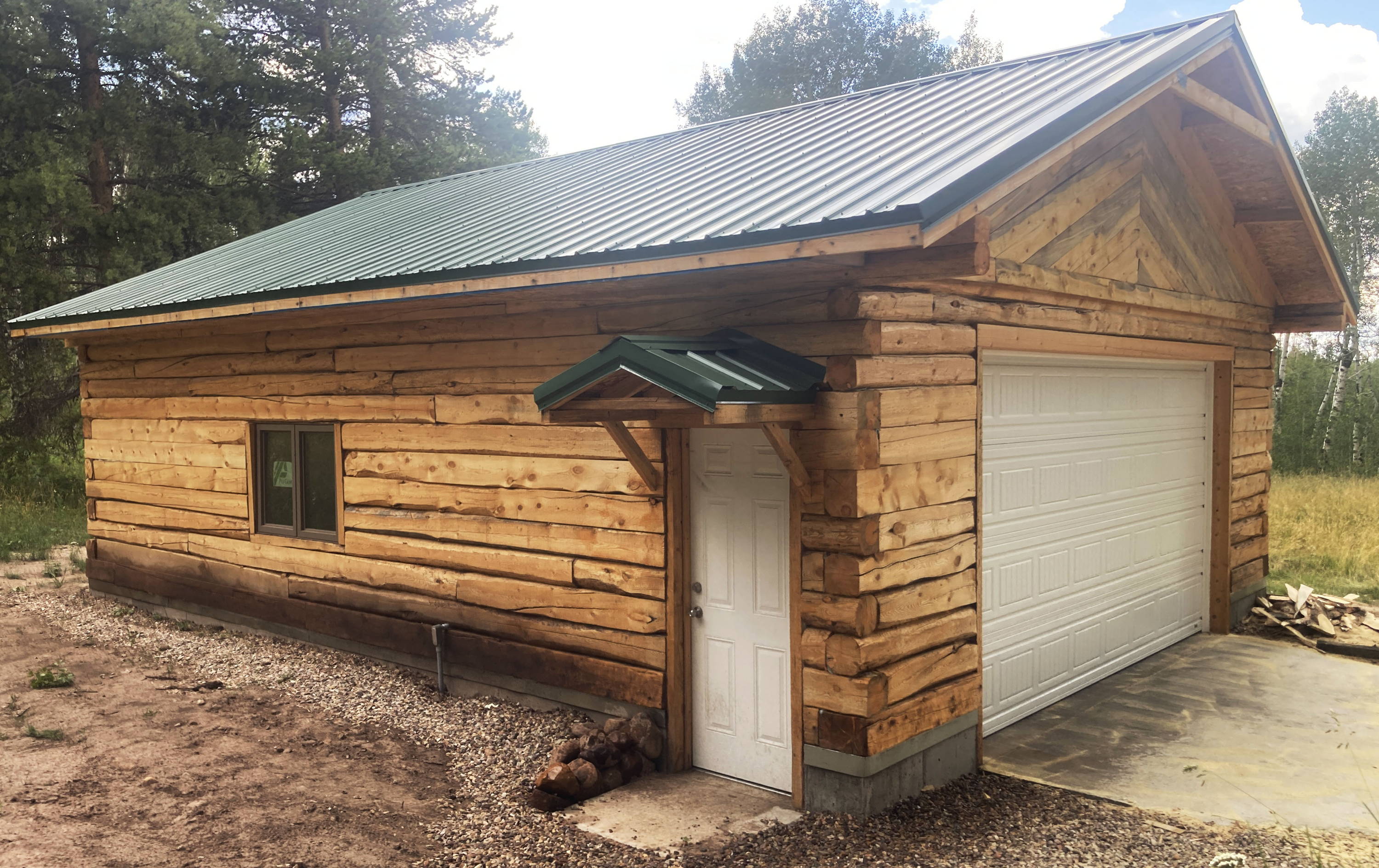 Log cabin style garage built with portable sawmill