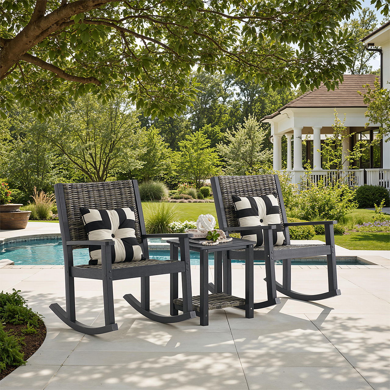 Two rocking chairs with cushions beside a pool in a garden setting.