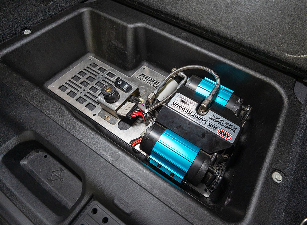 Two electric motors and control panel in a vehicle compartment.