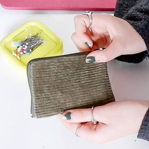 hands holding a handmade mini wallet pouch