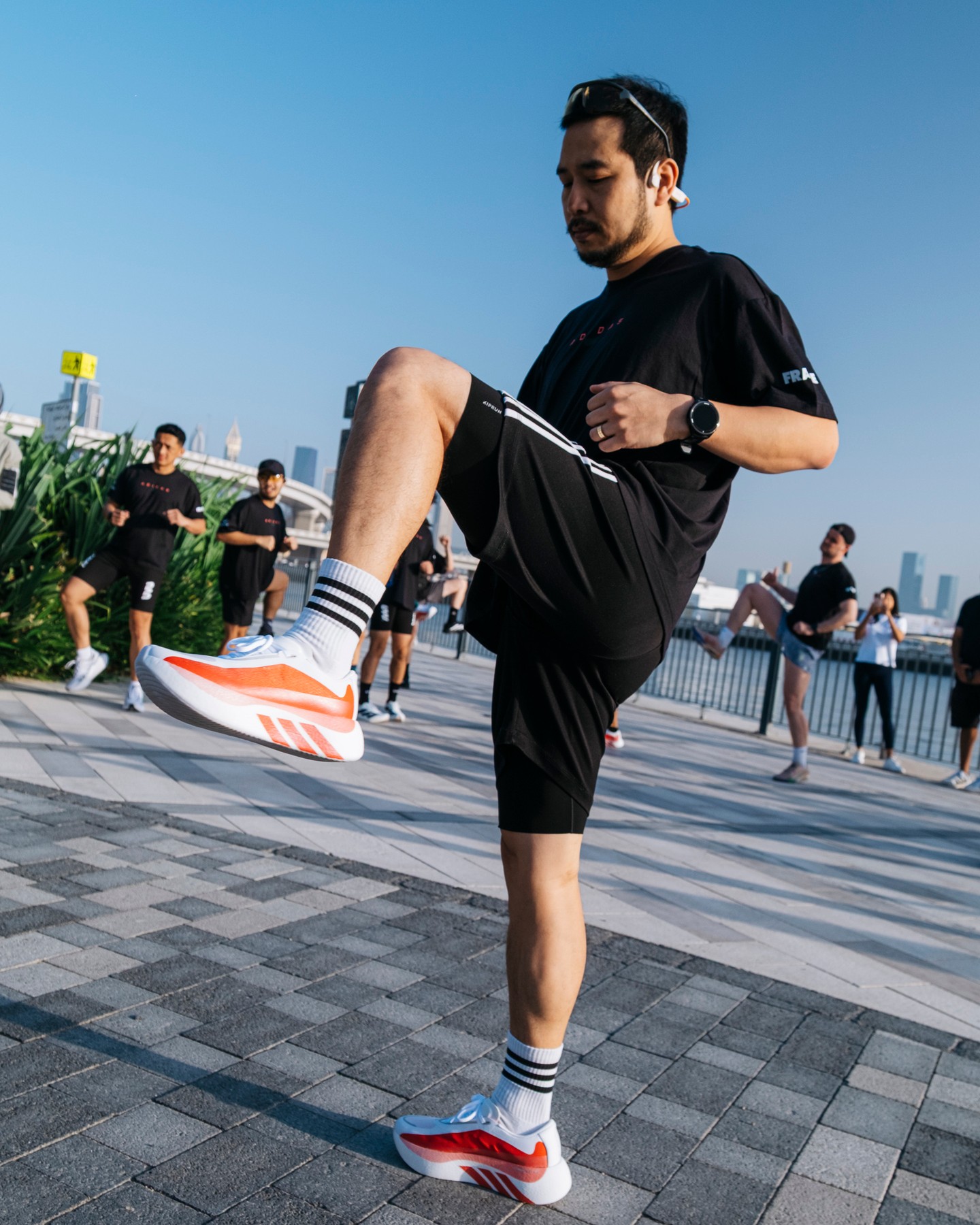 FRAME RUN CLUB runners warming up for the long run along dubai canal