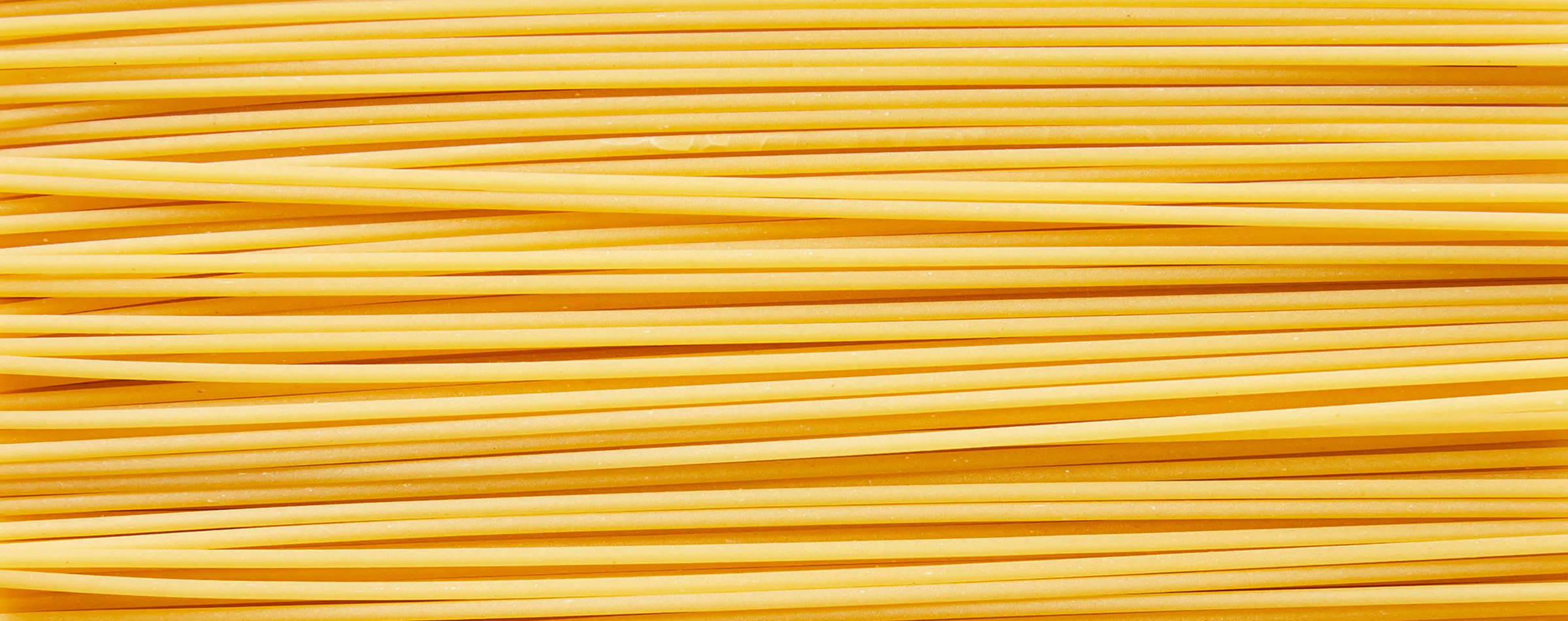 Zoomed in image of uncooked bucatini pasta