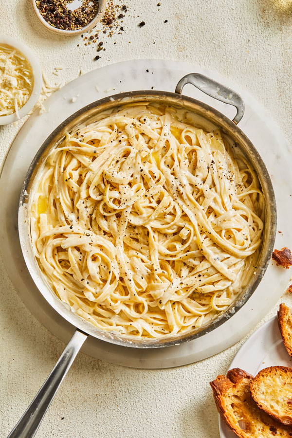 Fettuccine pasta in a creamy cheese Alfredo sauce with cracked black pepper