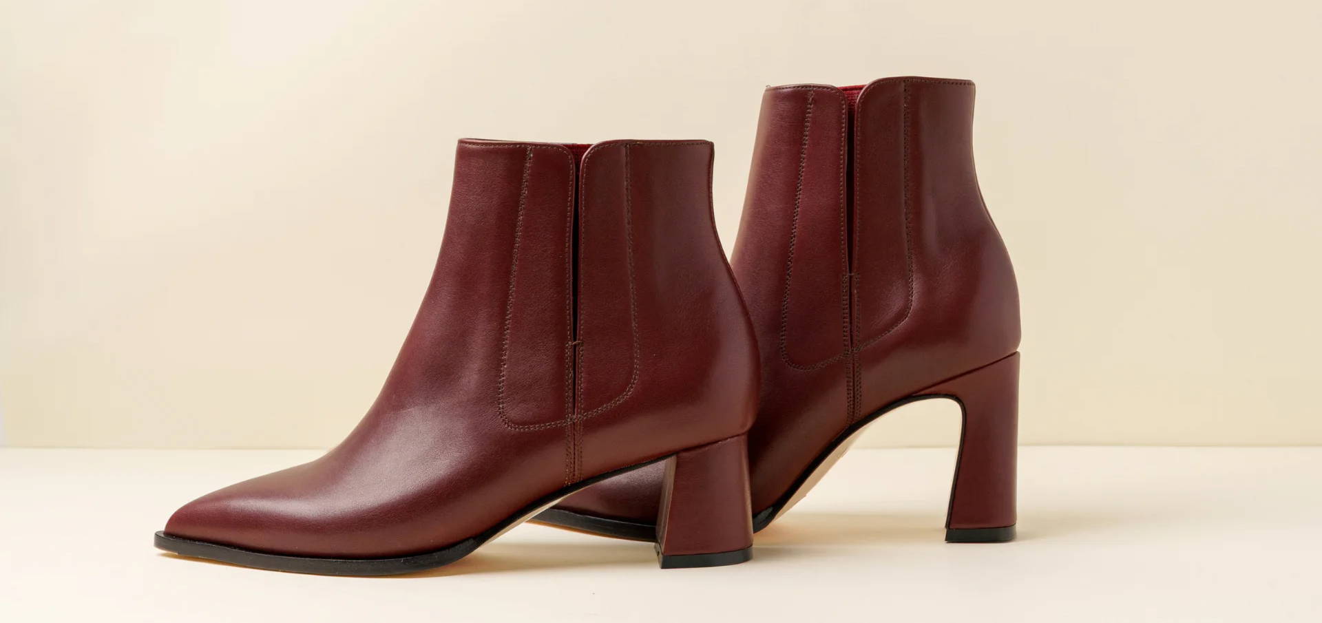 Pair of burgundy ankle boots with a block heel.
