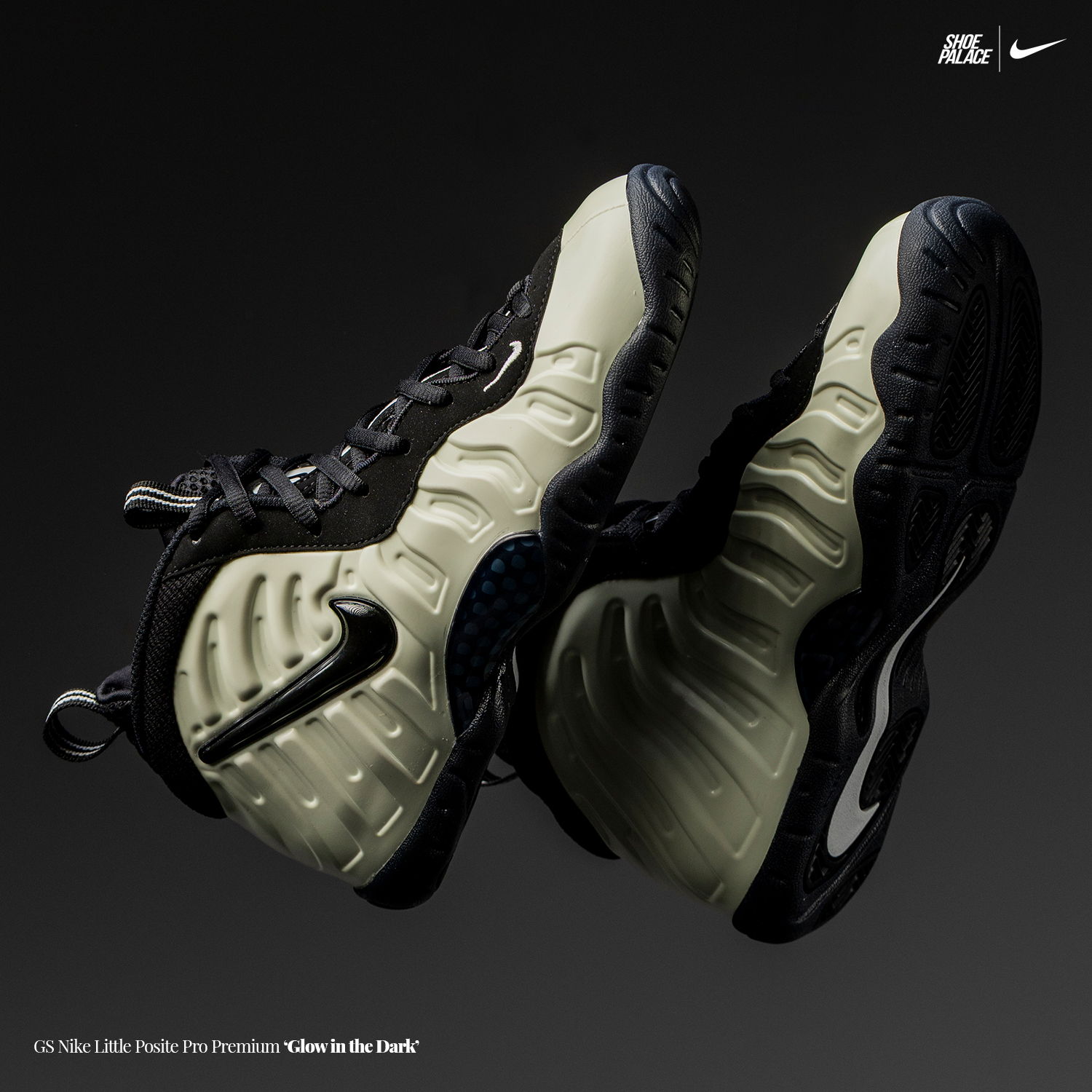 A pair of Nike Foamposite sneakers on a dark background.