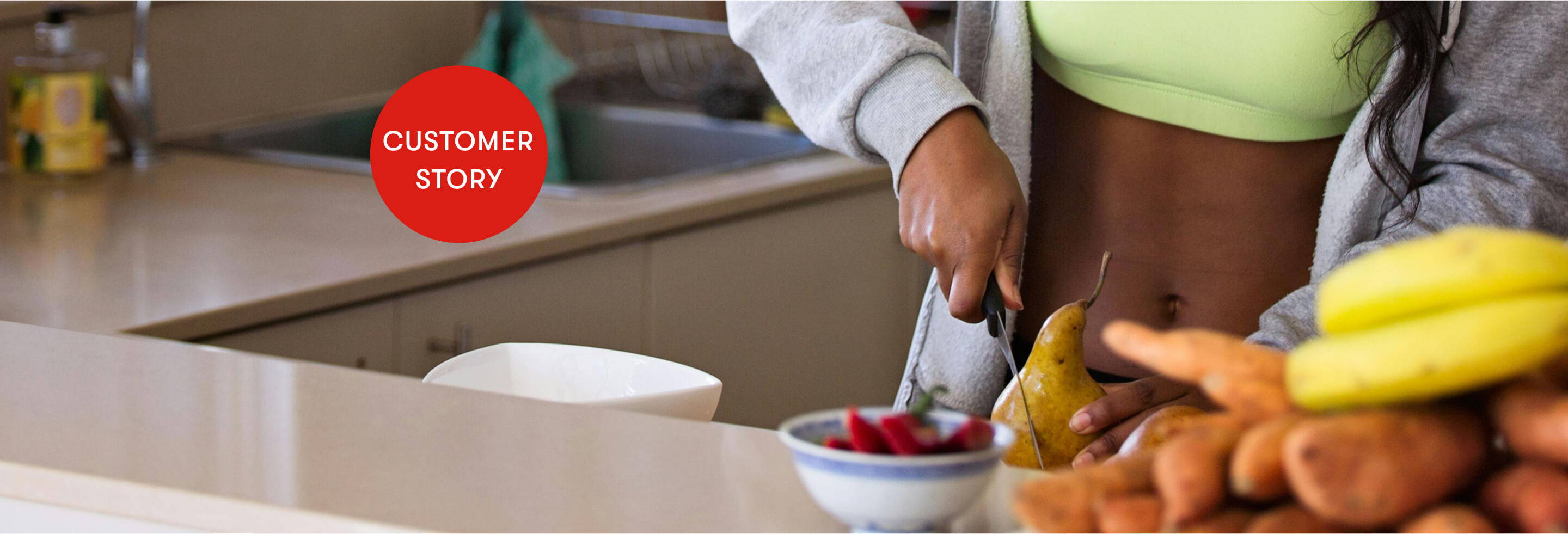Person preparing food with fruits and vegetables on a countertop.