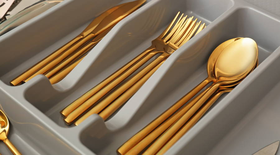 gold silverware cutlery in drawer