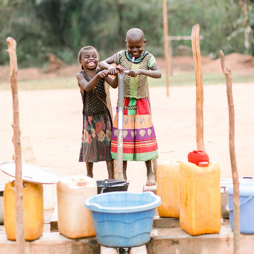 Two kids collecting water