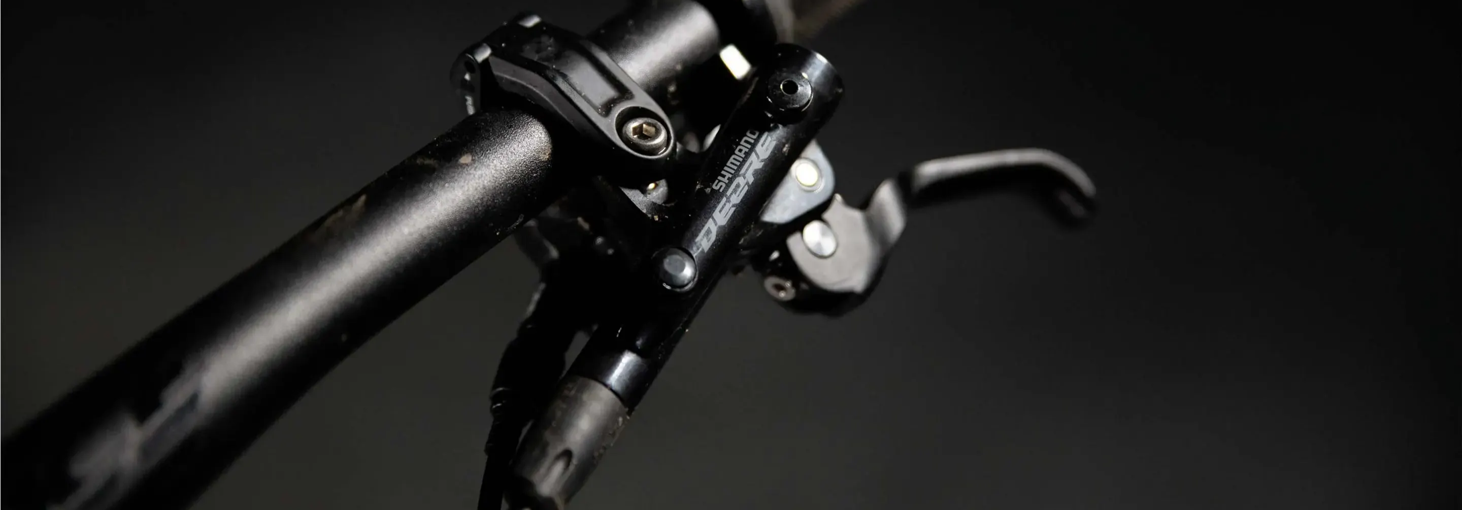 shimano deore mountain bike brake lever on a dark background