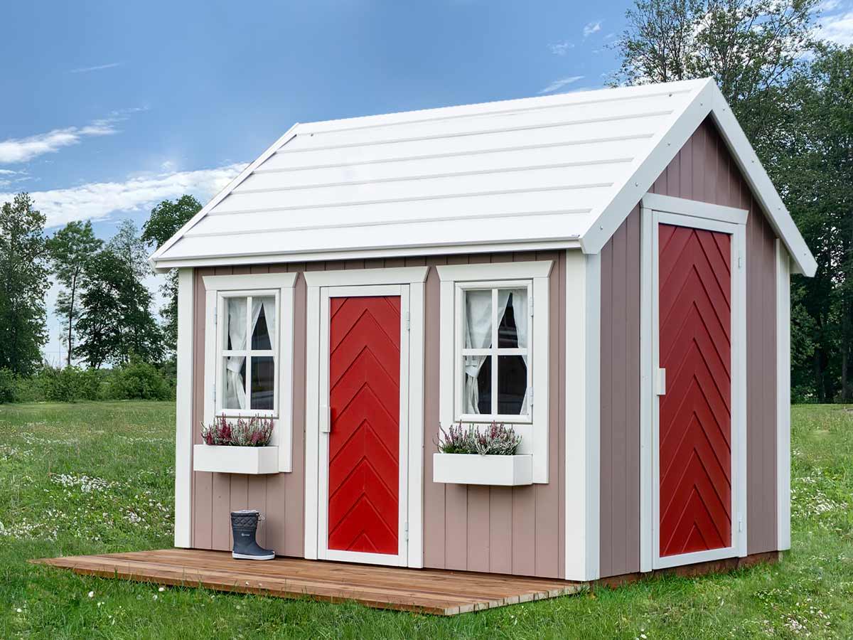 Outdoor Playhouse Plum with white flower boxes, wooden terrace and red herringbone door by WholeWoodPlayhouses