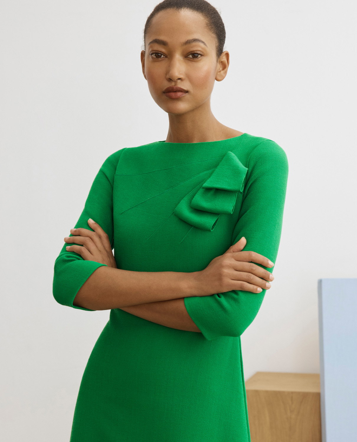Model wearing emerald green Verana dress
